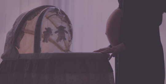 pregnant woman near bassinet